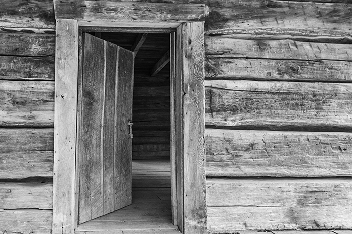 Log schoolhouse with wooden door open