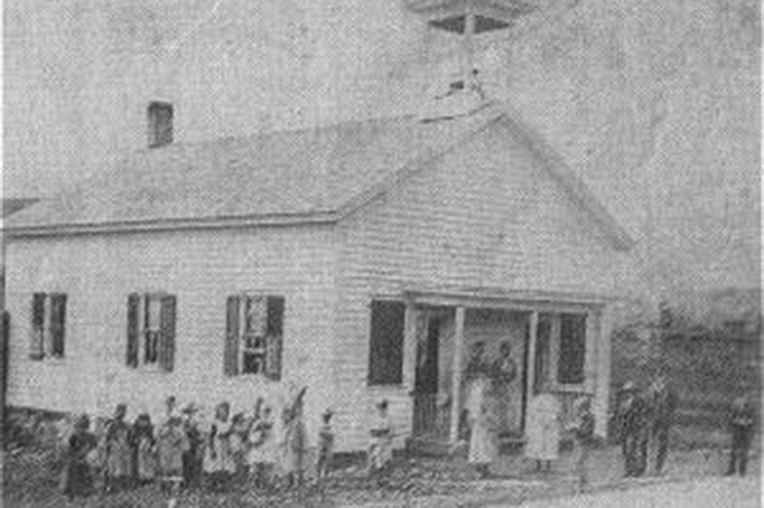 School building with children standing outside