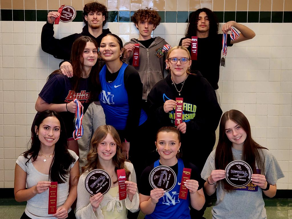 Ten students pose and hold up ribbons.