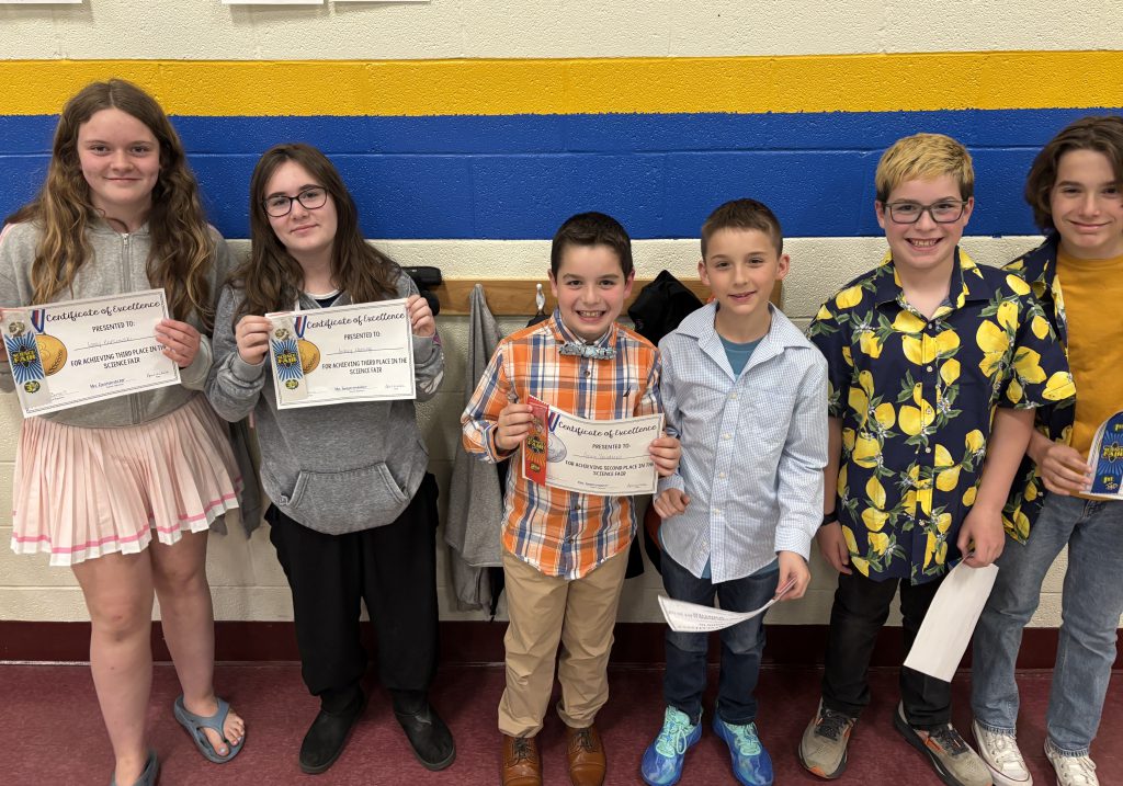 Six students smiling and holding certificates