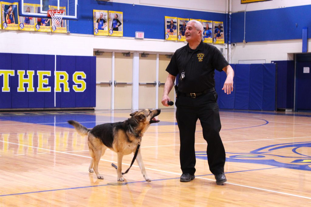 police officer stands with dog