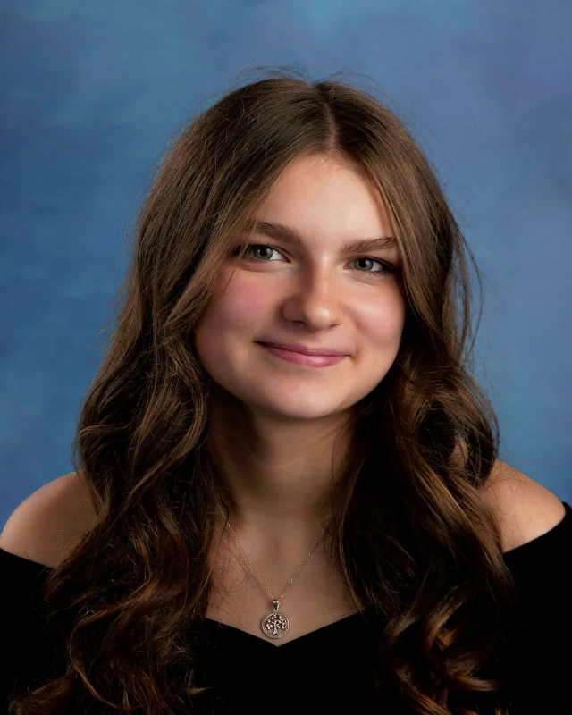 student in black with a blue background