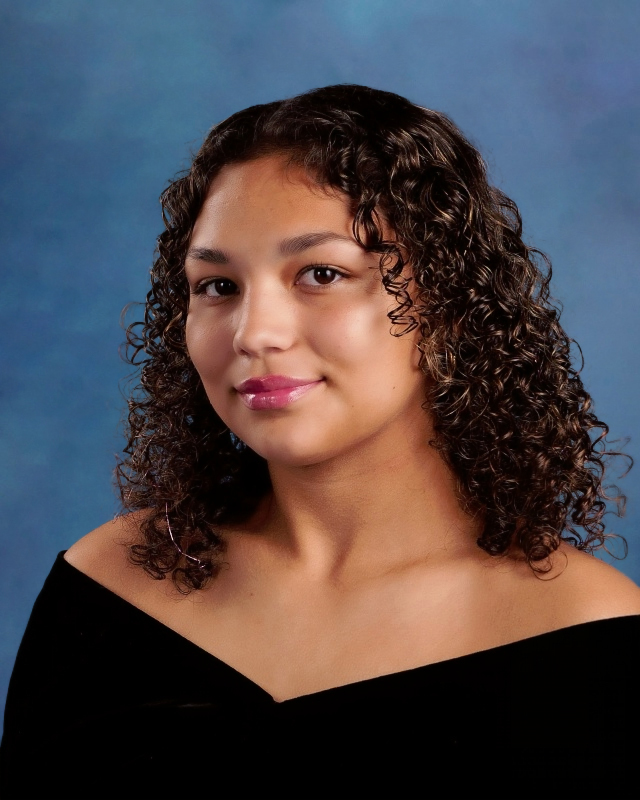 student in black with a blue background