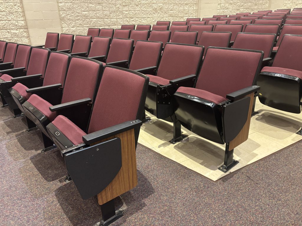 Rows of red auditorium seating
