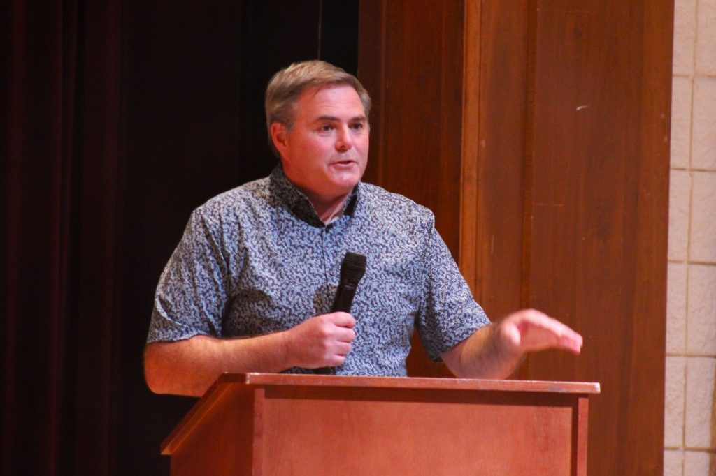 Man stands at podium with microphone