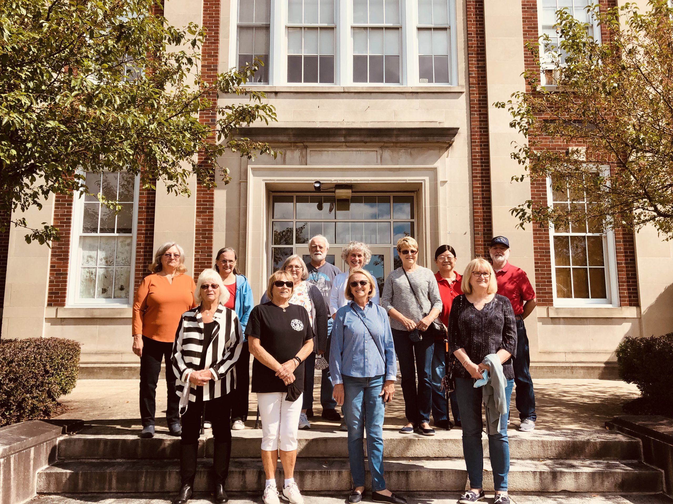 People standing on the steps of the school