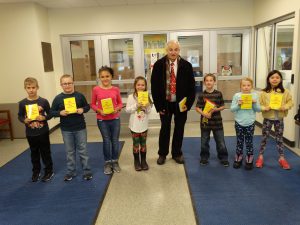 Student helpers pose with David Newkirk at school entrance