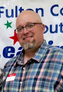 Man with glasses and beard smiling