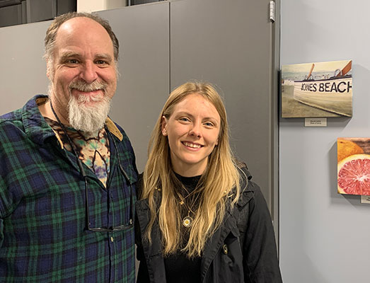 Mr. Lebediker standing next to Nicole next her painting