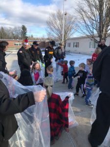 Helpers collect toys from students