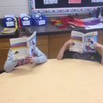 Student delving into reading two books