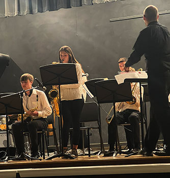 students on a stage playing instruments