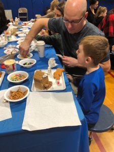 Dad and son work on a Gingerbread house