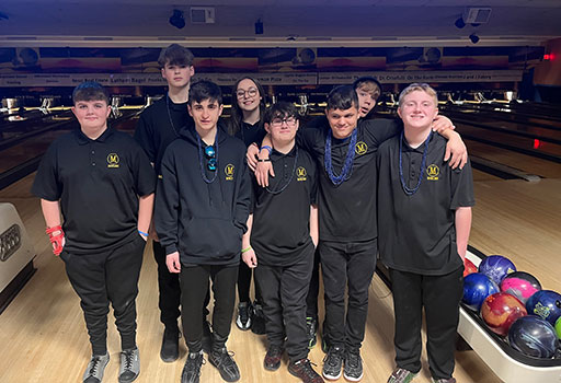Bowling team standing together as a group