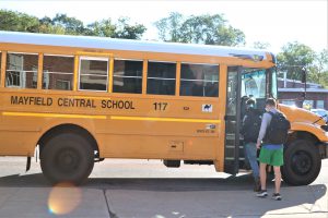 student getting on bus