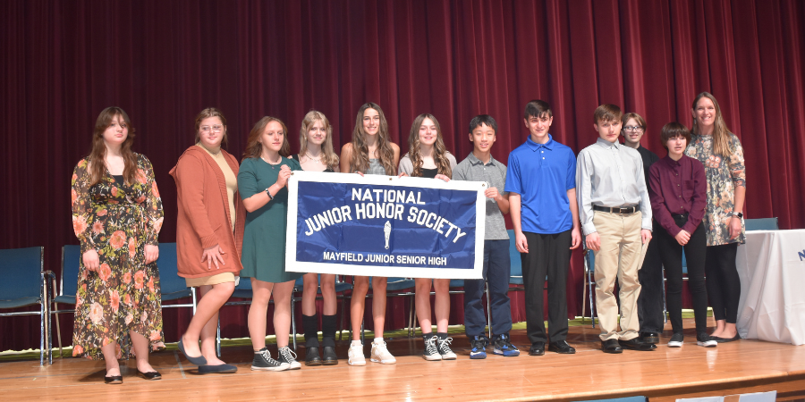 Students pose on stage for National Junior Honor Society photo