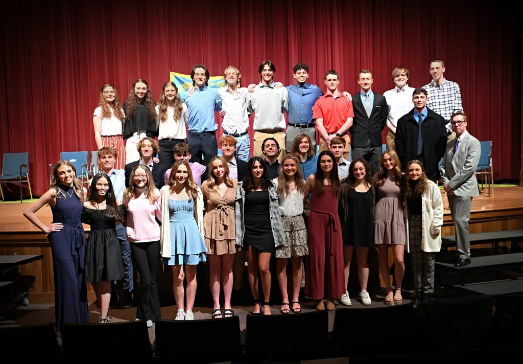 NHS members posing together on the stage
