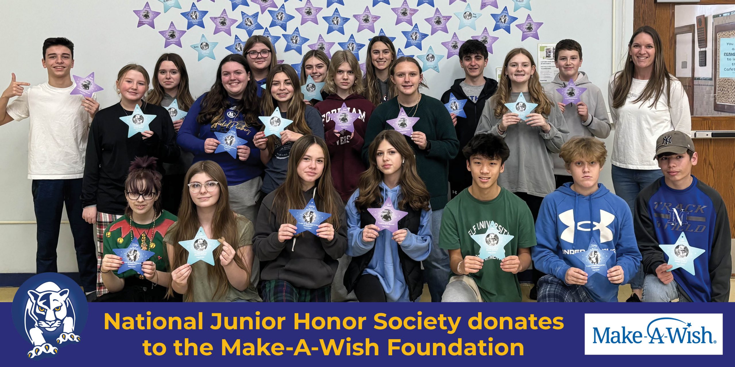 Students stand in three rows holding stars to represent their donation. The Mayfield Panther logo and Make-A-Wish logo are at the bottom in a blue bar with text saying National Junior Honor Society donates to Make-A-Wish Foundation.