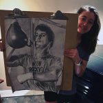 Student displaying her drawing of Rocky Balboa