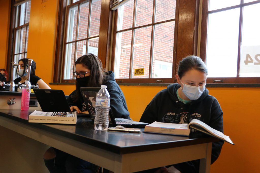 Students studying in front of window