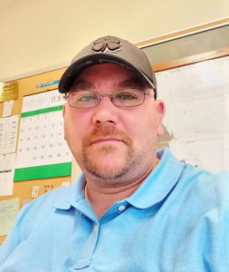 picture of a man in a blue shirt and hat