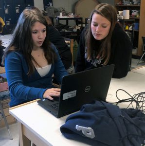 Two students work on a project