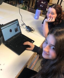 Two students look up from their work