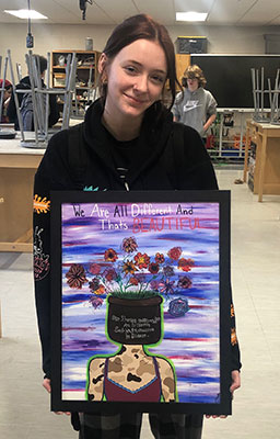 Bri holding her artwork