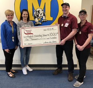 Stewarts officials handing a big check to elementary staff