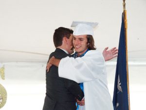 Principal hugs student