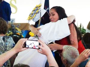 Student gives rose to parent