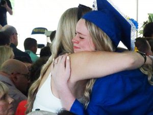 Student hugs parent