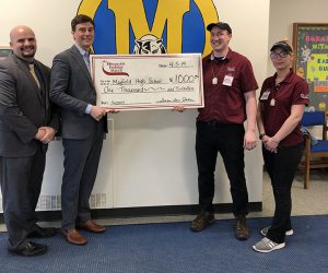 Stewart's officials hold a big check with Jr./Sr. High School staff
