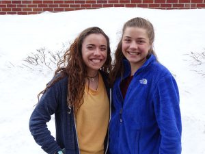 Students standing in front of snow bank