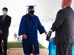 Student grabs diploma on the stage