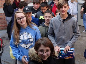 Several students carry gifts