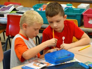 Two students work on a project