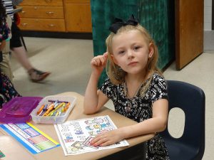 Student looks up while writing