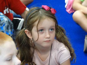 Student with pink hearts in her hair in class