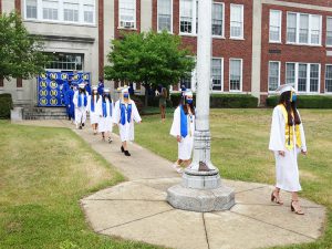 Students make the march from the school to the tent