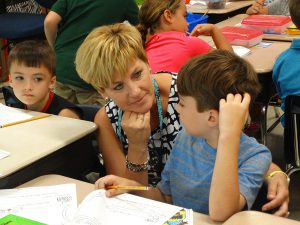 Principal talking to a student in class