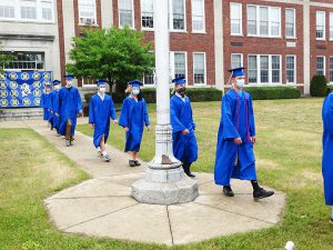 Students marching into the tent before the ceremony