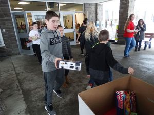 Student in grey shirt drops off gift