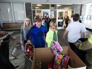 Student in blue shirt drops gift