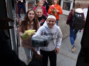 Smiling students with gifts