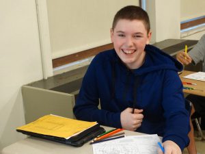 Student smiles while sitting in class