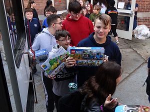 Students bringing gifts to the bus