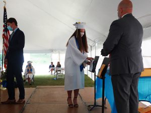 Student picks up diploma and awards on state