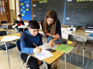 Math teacher helps a student