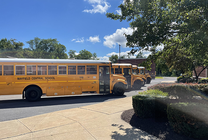 buses parked diagonally in front of HS